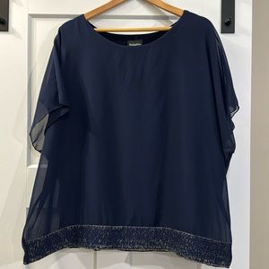 Dark Navy blouse with gold detail on bottom. Brand name is Initiatives.